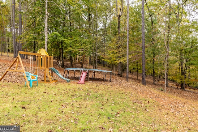 view of playground with a lawn and a trampoline