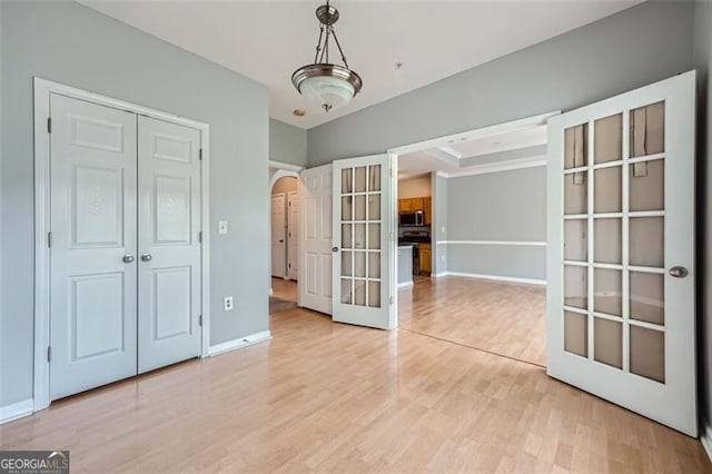 unfurnished bedroom featuring a closet and light hardwood / wood-style flooring