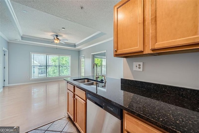 kitchen featuring a textured ceiling, sink, dishwasher, a tray ceiling, and dark stone countertops