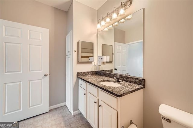 bathroom featuring toilet and vanity