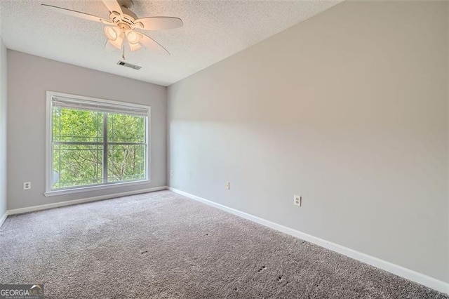 carpeted empty room featuring a textured ceiling, vaulted ceiling, and ceiling fan