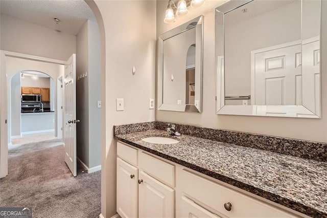 bathroom featuring vanity and a textured ceiling