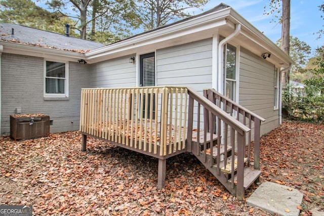 wooden deck featuring central air condition unit