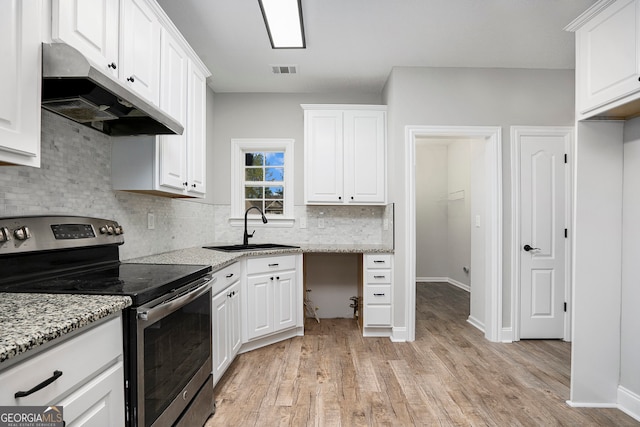 kitchen with light stone countertops, light wood-type flooring, sink, white cabinets, and stainless steel electric range oven