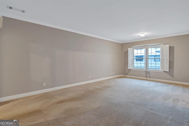 unfurnished room with light colored carpet and ornamental molding