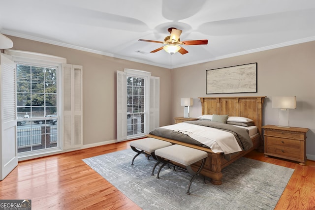 bedroom featuring ornamental molding, access to exterior, ceiling fan, and light hardwood / wood-style flooring