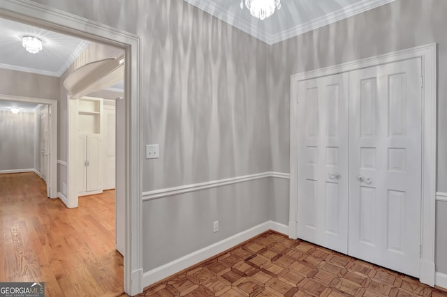 corridor featuring crown molding and light hardwood / wood-style floors