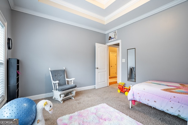 carpeted bedroom with a raised ceiling and crown molding