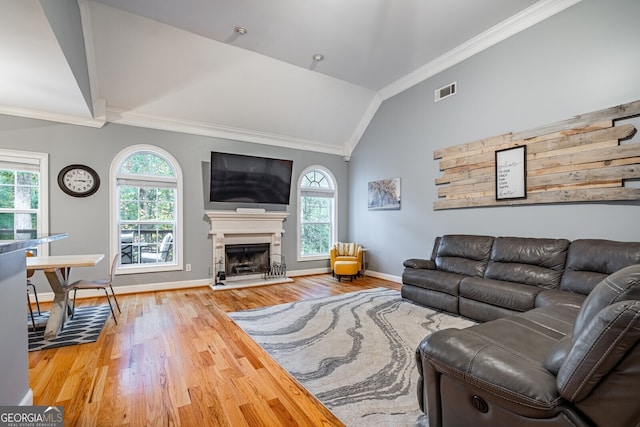 living room with crown molding, wood-type flooring, and vaulted ceiling