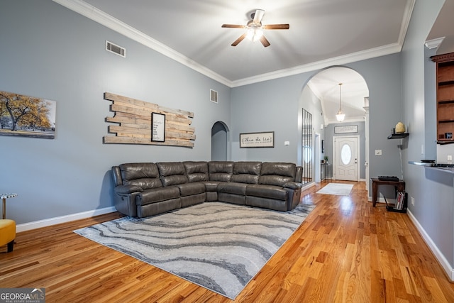 living room with hardwood / wood-style flooring, ceiling fan, and crown molding