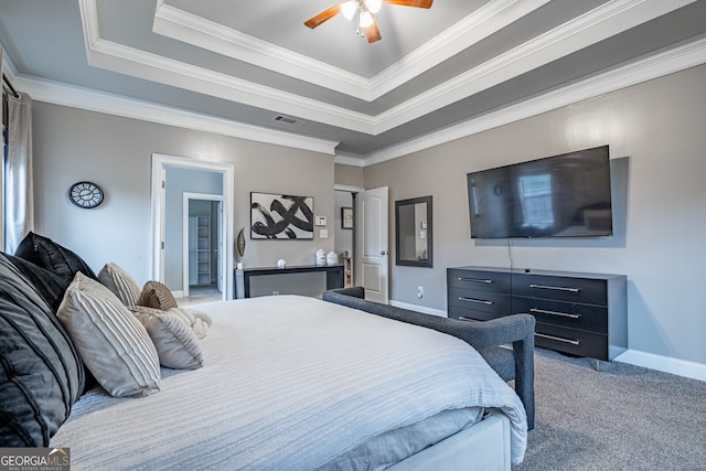 bedroom featuring carpet, a tray ceiling, ceiling fan, and ornamental molding