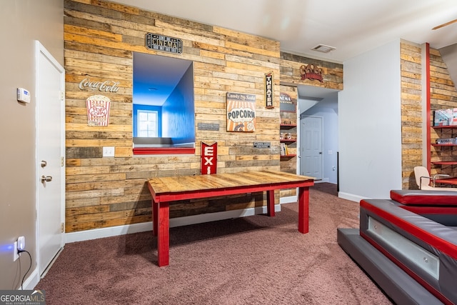 recreation room with carpet flooring and wooden walls