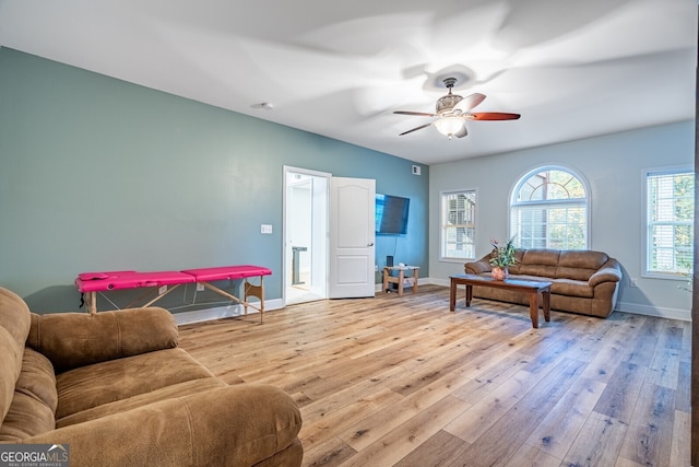 living room featuring ceiling fan and light wood-type flooring