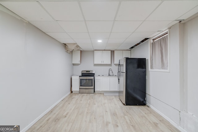 kitchen with white cabinetry, sink, appliances with stainless steel finishes, a drop ceiling, and light hardwood / wood-style flooring