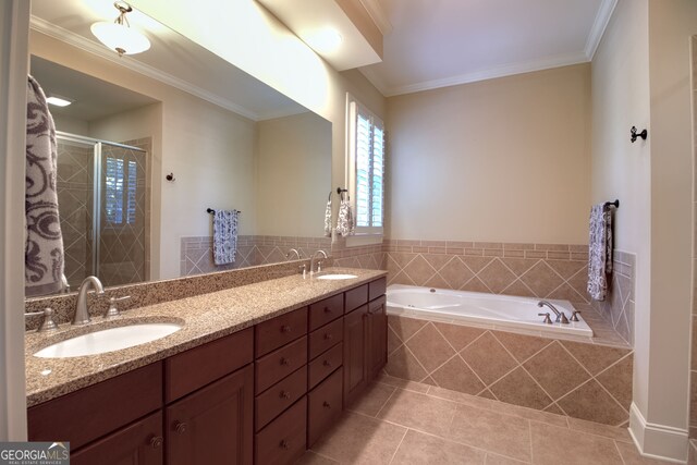 bathroom featuring plus walk in shower, vanity, tile patterned floors, and crown molding