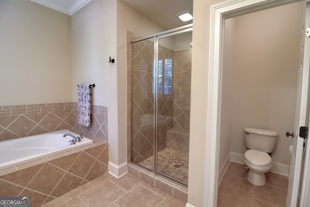 bathroom with tile patterned flooring, separate shower and tub, toilet, and crown molding