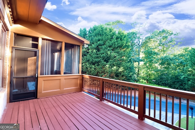 wooden deck with a sunroom