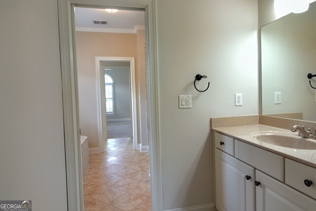 bathroom with vanity, tile patterned floors, and crown molding