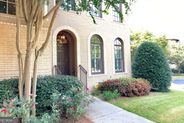 doorway to property featuring a yard