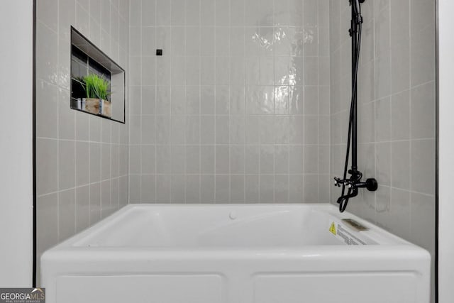 full bathroom featuring a washtub and tile walls