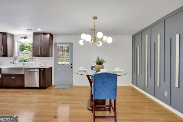 kitchen featuring light wood-style floors, dark brown cabinets, light countertops, and dishwasher