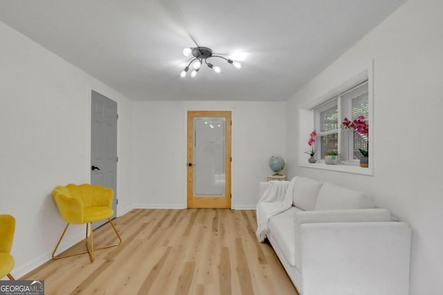 living area featuring baseboards and wood finished floors