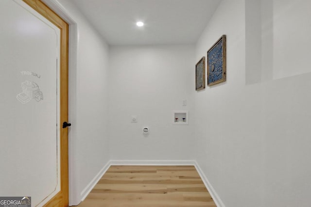 laundry area with light wood-type flooring, hookup for a washing machine, baseboards, and hookup for an electric dryer