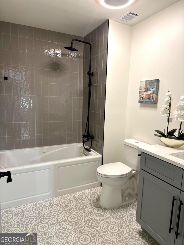 bathroom with visible vents, toilet, vanity,  shower combination, and tile patterned floors