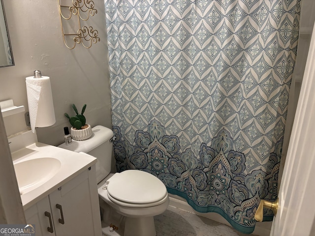 bathroom with curtained shower, vanity, and toilet