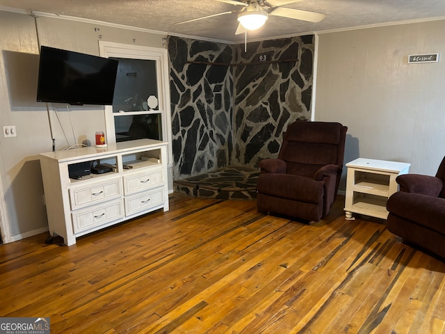 living room with ceiling fan, dark hardwood / wood-style floors, and crown molding