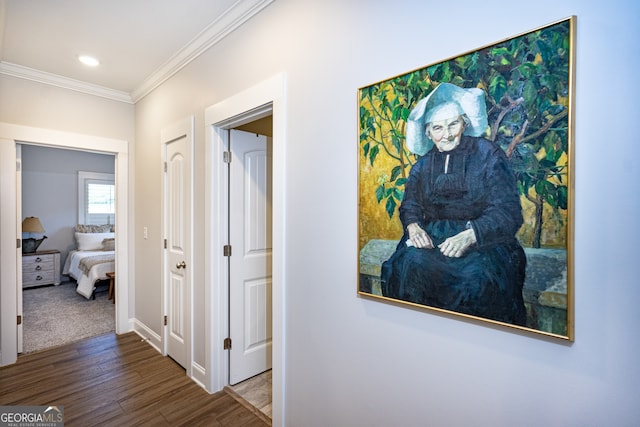 hallway with ornamental molding and hardwood / wood-style flooring