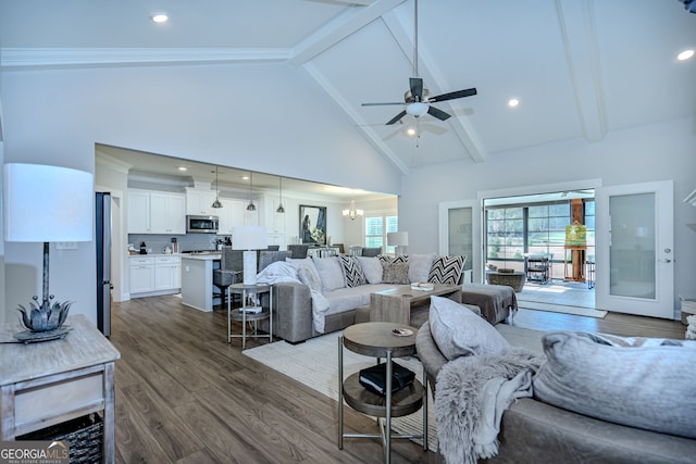 living room featuring ceiling fan with notable chandelier, dark hardwood / wood-style flooring, high vaulted ceiling, and beamed ceiling