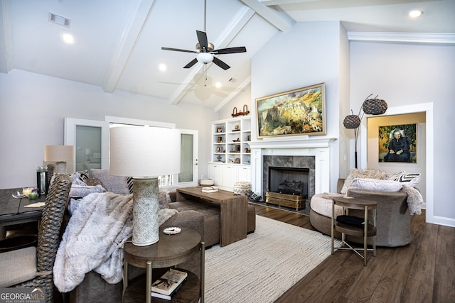 living room featuring a tile fireplace, beam ceiling, and dark hardwood / wood-style floors