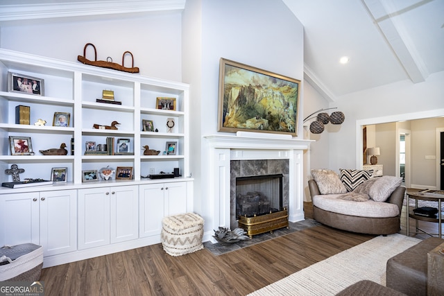 living room featuring vaulted ceiling with beams, crown molding, a tile fireplace, and dark hardwood / wood-style flooring