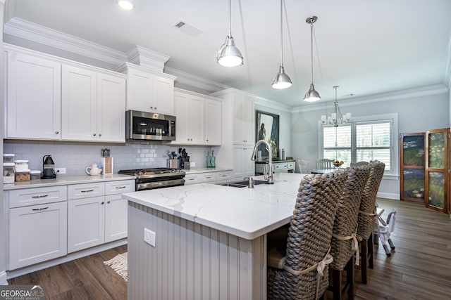 kitchen with white cabinetry, sink, an island with sink, and stainless steel appliances