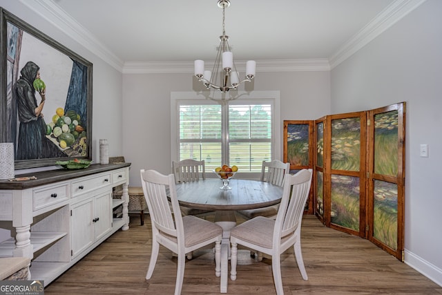 dining room with hardwood / wood-style floors, a chandelier, and ornamental molding