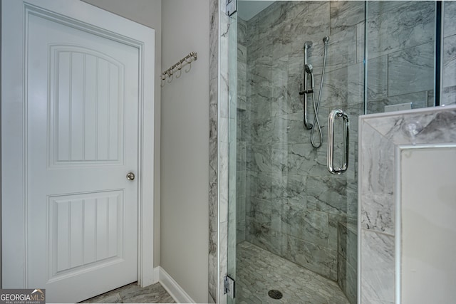 bathroom with a shower with door