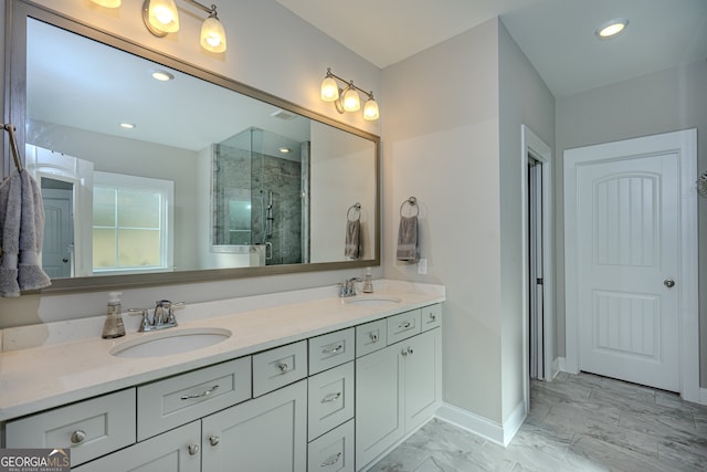 bathroom with vanity and a shower with door