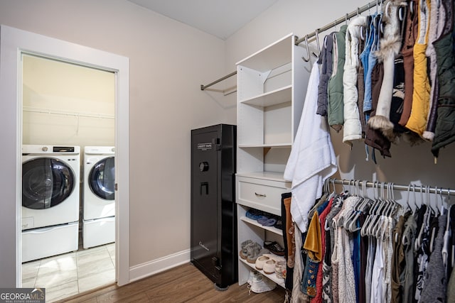 laundry area with separate washer and dryer and dark wood-type flooring