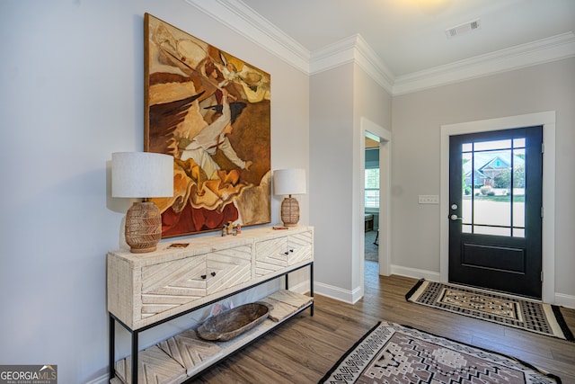 foyer featuring dark wood-type flooring and ornamental molding