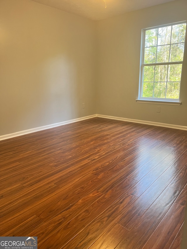 spare room with dark hardwood / wood-style flooring