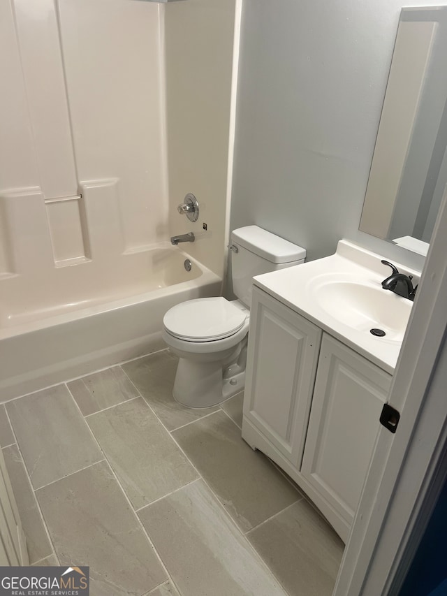 full bathroom with tile patterned floors, vanity, bathing tub / shower combination, and toilet