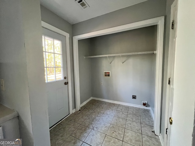 clothes washing area featuring washer hookup, light tile patterned floors, and hookup for an electric dryer