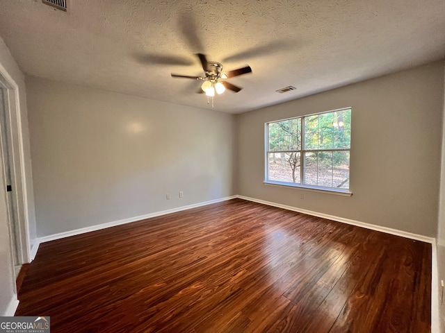 unfurnished room featuring ceiling fan, a textured ceiling, and dark hardwood / wood-style flooring