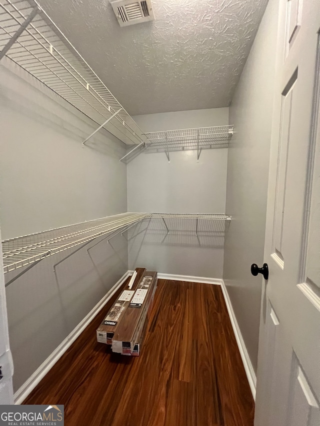 spacious closet featuring hardwood / wood-style floors