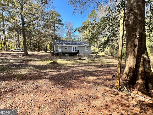 back of property featuring a wooden deck