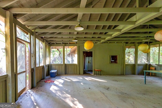 unfurnished sunroom featuring lofted ceiling