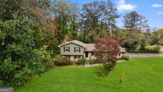 split level home featuring a front lawn