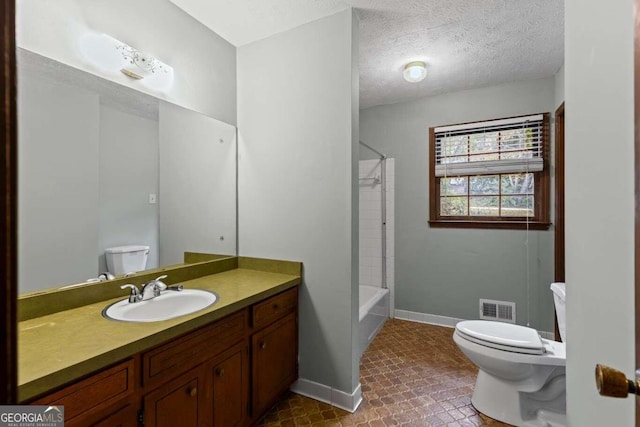 full bathroom featuring tile patterned flooring, a textured ceiling, vanity, shower / bathing tub combination, and toilet