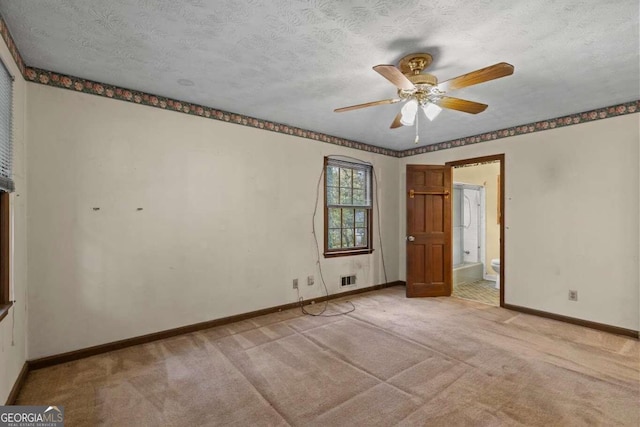 unfurnished room with a textured ceiling, light colored carpet, and ceiling fan